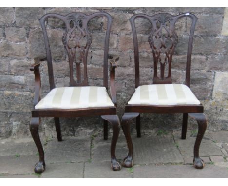 A set of six (4+2) Edwardian Chippendale revival dining chairs with pierced Gothic tracery splats drop in upholstered seats a