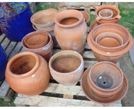 A quantity of terracotta flower pots and planters of varying size and design (19) including a quantity of circular water tray