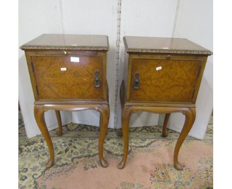 A pair of walnut and figured walnut bedside or lamp tables, in the Queen Anne style, the doors with quarter veneered detail r