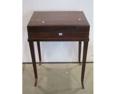 A fold over top games table on square tapered legs, the interior revealing a backgammon board with counters, etc