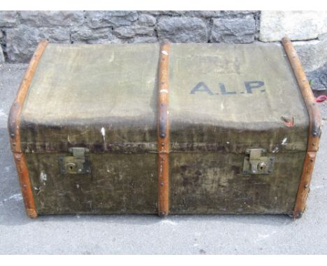 Two vintage travel trunks with canvas skins and timber lathes