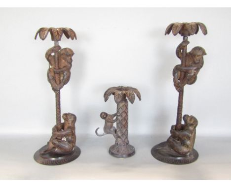 A pair of novelty candlesticks in the form of monkeys climbing palm trees, 36cm high, together with a further novelty candles