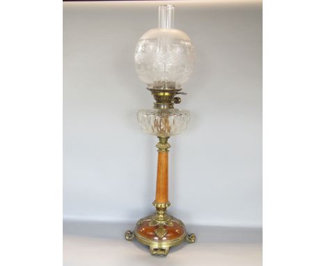 A good quality oak and cast brass art nouveau oil lamp, the glass shade and reservoir upon a tapered column with good cast br