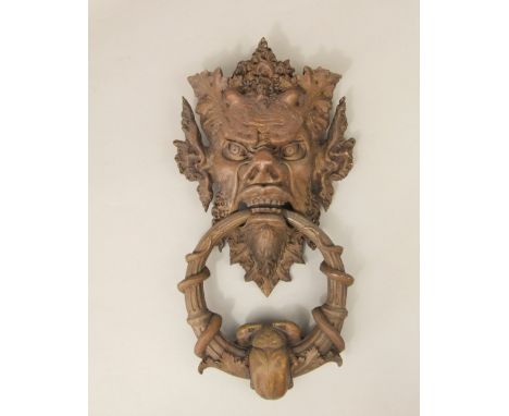 Good quality cast bronze door knocker, the back in the form of a mythical beast mask, the knocker with coiled serpents and a 