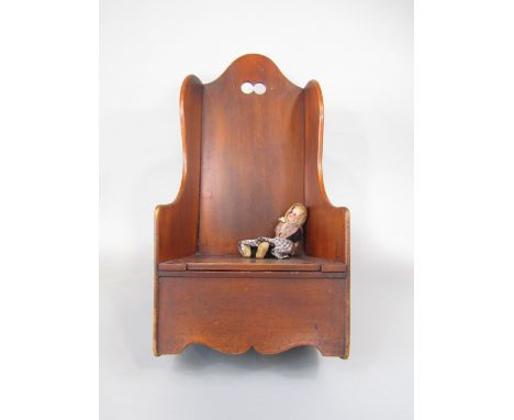 Antique fruitwood child's or dolls rocking chair with hinged commode seat, 65cm high; together with a further porcelain heade