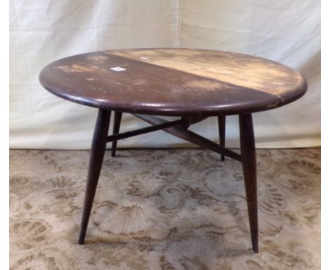 A small Ercol dark stained elm and beechwood oval single drop leaf occasional table raised on four splayed supports united by