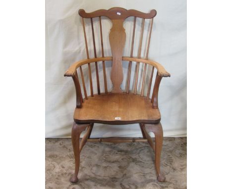 An 18th century style Windsor stick back elbow chair with yoke shaped cresting rail and vase shaped splat, saddle seat and sh