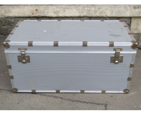 A substantial aluminium clad travel trunk with strengthened bands