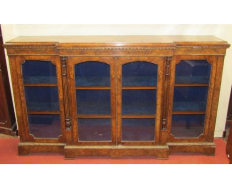 A mid Victorian figured walnut breakfront four door credenza with string inlaid detail, further etched detail and ormolu moun