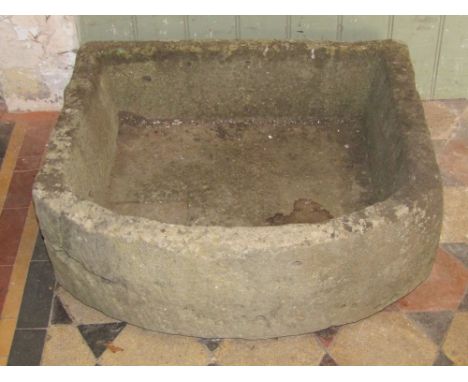 A natural stone trough with single D shaped end and drainage hole, 61cm wide x 20cm deep