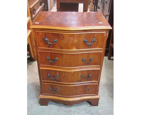 A small reproduction Georgian style yew wood veneered chest, the serpentine shaped front fitted with four long drawers, raise