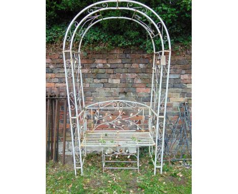 A contemporary cream painted light steel framed garden arbour and combined bench seat with decorative trailing floral detail,