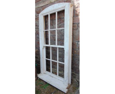 A painted bespoke pine sash window with slightly arched frame and vacant glass panels, 180 cm high x 93 cm wide, excluding si