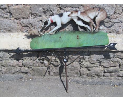 A contemporary weather vane, the cut sheet steel and enamel painted finial with hare coursing scene