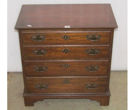 A small Georgian style chest of four long graduated drawers with swan neck handles, raised on bracket supports stamped to top