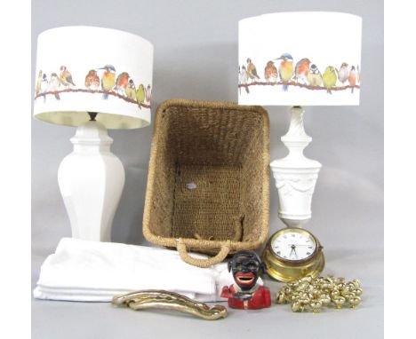 A collection of miscellaneous items to include a bulk head type time piece, a cast iron novelty money box, two porcelain lamp