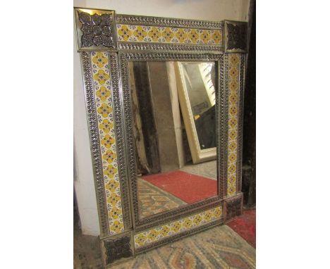 A decorative Moroccan style wall mirror with tin and ceramic panelled framework, 85 x 65cm