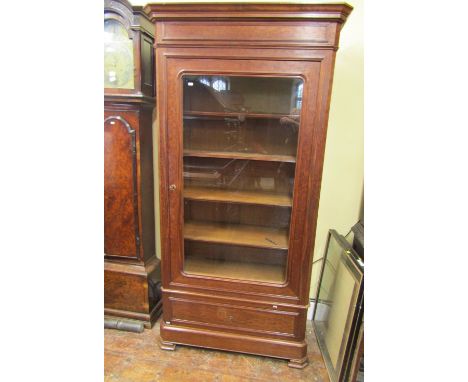 A substantial mahogany bookcase or display cabinet enclosed by a single glazed panelled door over a frieze drawer, 100cm wide