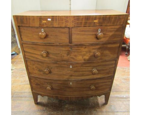 A Regency mahogany bow fronted chest of three long and two short drawers with caddy top and string inlaid detail on swept sup