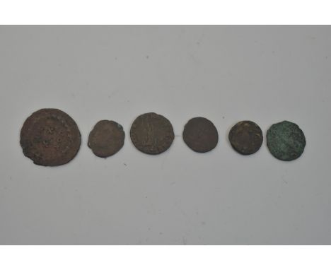 Six Ancient Roman coins, circa 4th Century AD; and a terracotta oil lamp.