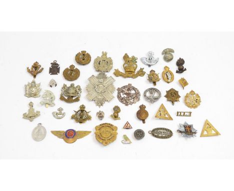 A collection of military cap badges, shoulder titles and collar badges and other badges, comprising, Manchester 5th Volunteer