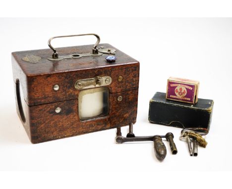 A Junds-Thexor pigeon racing timing clock, supplied by T. Hudson's Exors Ltd., Manchester, with accessories, 19cms.