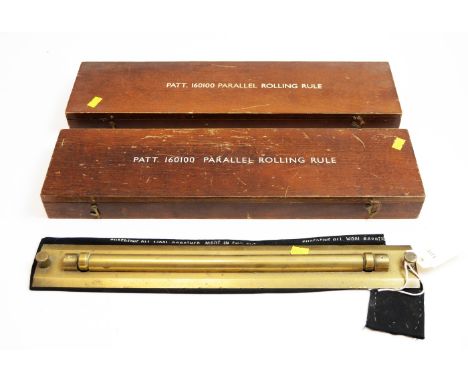 Two Admiralty pattern rolling rulers, each with War Office arrow, contained in wooden cases; and another in soft cloth case. 