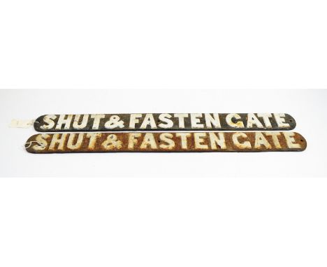 Two cast iron railway 'Shut and Fasten Gate' signs.