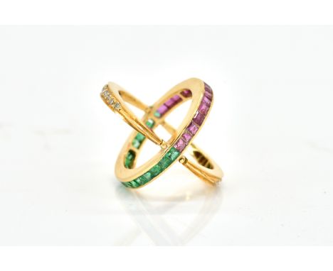 A GOLD, EMERALD, RUBY AND DIAMOND SWING OVER AND UNDER ETERNITY RINGThe principal band mounted with square cut emeralds to on