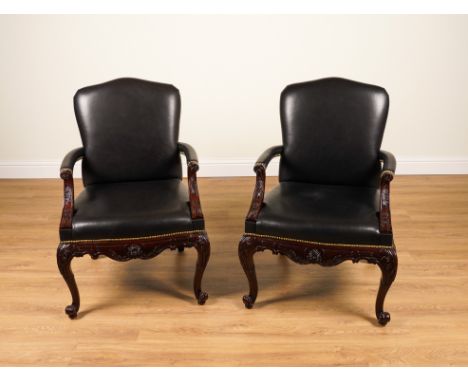 RALPH LAUREN; A PAIR OF CLIVEDON CARVED BRASS STUDDED BLACK LEATHER UPHOLSTERED OPEN ARMCHAIRS WITH CARVED HARDWOOD FRAMES (2