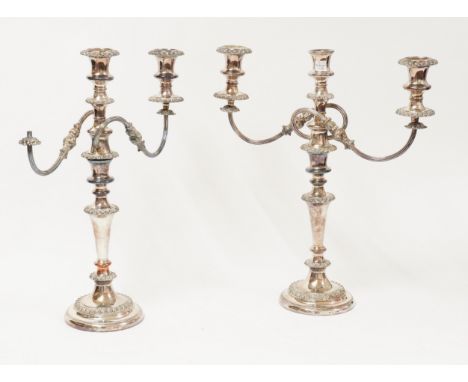 A PAIR OF PLATED THREE LIGHT TABLE CANDELABRA (3 including loose sconce)Each with twin scrolling arms, decorated with gadroon