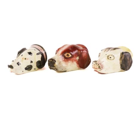 THREE STAFFORDSHIRE POTTERY HOUND HEAD STIRRUP CUPS (3)19th centuryThe largest with brown markings, another with black markin