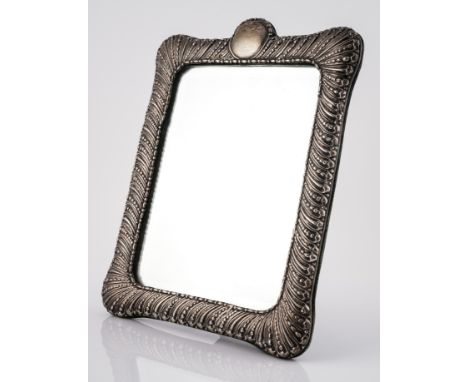 A VICTORIAN SILVER MOUNTED SHAPED RECTANGULAR STRUT BACKED MIRRORHaving beaded and fluted banded decoration and with a vacant