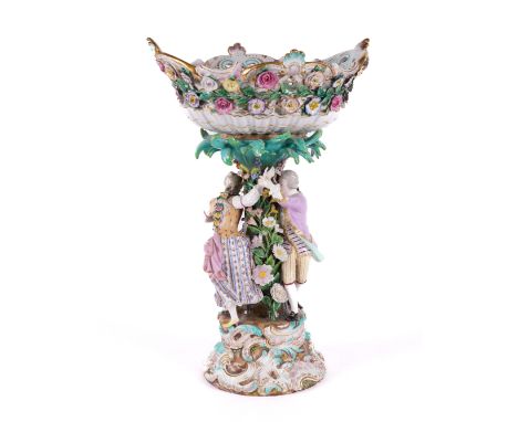 A MEISSEN PORCELAIN CENTREPIECELate 19th centuryModelled as a gallant and companion chasing each other round a flower encrust