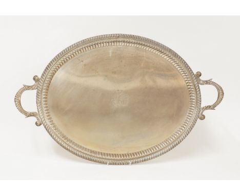A GEORGE III SILVER TWIN HANDLED OVAL TRAYWith gadrooned decoration to the wide border within a fluted band, crest engraved, 