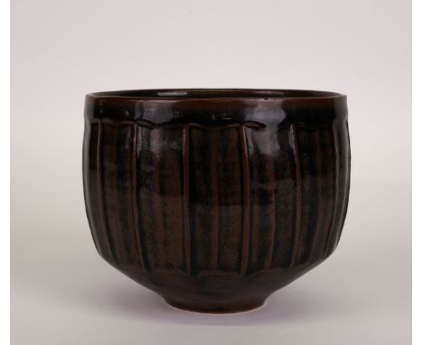 DAVID LEACH ( 1911-2005) A STUDIO POTTERY BOWLStoneware, fluted body beneath a tenmoku glaze, impressed DL seal, 13.25cm high