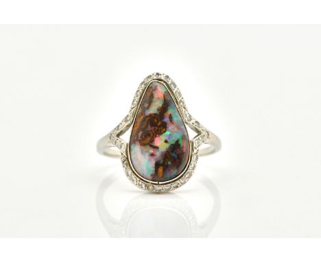 AN OPAL AND DIAMOND RINGSet with a pear shaped boulder opal, surrounded by diamonds, in platinum, size P 1/2, gross weight 4.