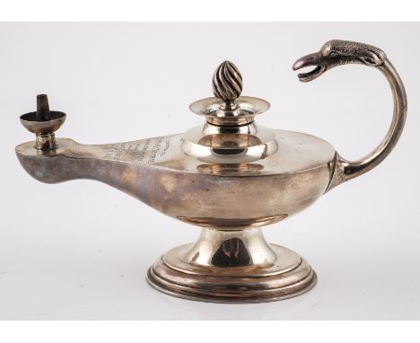 A SILVER TABLE LIGHTERModelled as a classical oil lamp, presentation inscribed 'Presented to Captain E.C. Severneon the occas