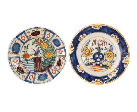 TWO DUTCH DELFT POLYCHROME PLATES (2)Circa 1770One painted with an insect on a rock amongst flowers, the other with a pierced