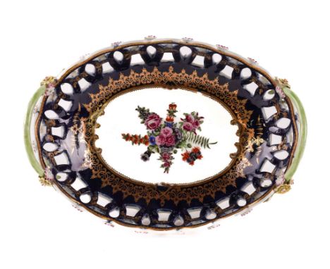 A WORCESTER PIERCED BLUE-GROUND TWO-HANDLED OVAL BASKETCirca 1770The sides pierced with interlinked circles, applied with flo
