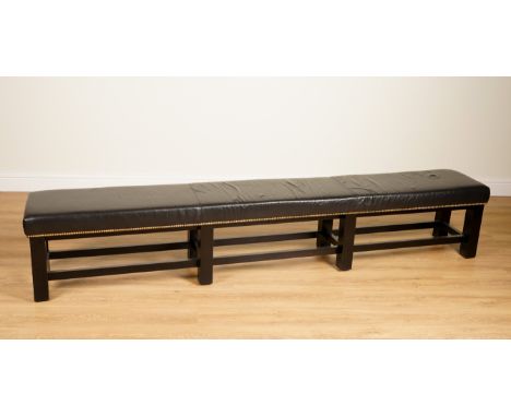 A PAIR OF BRASS STUDDED BLACK LEATHER UPHOLSTERED LONG RECTANGULAR STOOLS (2)With block ebonised frame; 262cm long; 40cm deep