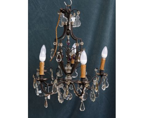 A FRENCH LOUIS XV STYLE WROUGHT IRON AND GLASS FIVE LIGHT CHANDELIER20th CenturyThe branches decorated with leaves, the centr