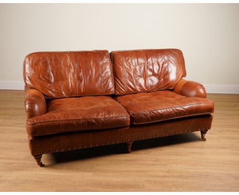 A MODERN STUDDED BROWN LEATHER UPHOLSTERED THREE SEATER SOFA (2)188cm wide; 80cm high, together with a matching armchair, 90c