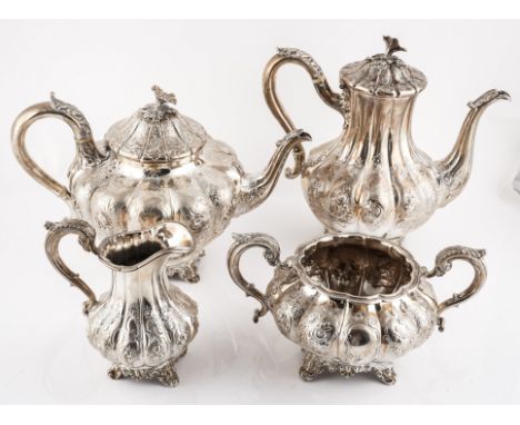 A SILVER COMPOSITE FOUR PIECE TEA SETEach piece of baluster panelled form with matching floral, foliate and scroll embossed d