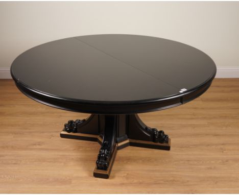 RALPH LAUREN; A BLACK LACQUER CIRCULAR EXTENDING DINING TABLE ON LION’S PAW PEDESTALWith one extra leaf, 152cm diameter; 223c