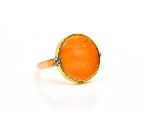 A GOLD AND CORNELIAN ROTATING INTAGLIO SIGNET RINGThe circular cornelian engraved to both sides, ring size approx K and a hal