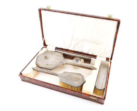 A LADY'S SILVER MOUNTED FOUR PIECE DRESSING SET AND A SILVER RIMMED GLASS MATCH STRIKING STAND (5)The dressing set comprising