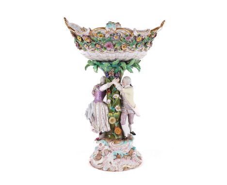 A MEISSEN PORCELAIN CENTREPIECELate 19th centuryModelled as a gallant and companion chasing each other around a flower encrus