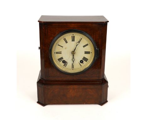 A BRASS INLAID WALNUT MANTEL CLOCK19th Century 
The case with canted front angles, the enamelled dial with twin train movemen