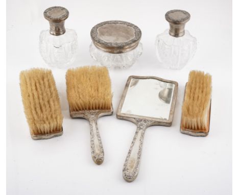 A CONTINENTAL SEVEN-PIECE DRESSING SET (7)Comprising; a pair of faceted glass scent bottles, a glass powder bowl and cover, a